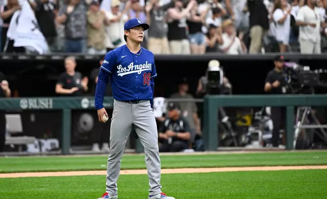 Los Angeles Dodgers pitcher Yoshinobu Yamamoto of Japan, looks on after Chicago White Sox' Tristan Peters hit a home run during the ninth inning of a baseball game, Saturday, June 13, 2026, in Chicago. (AP Photo/Matt Marton)