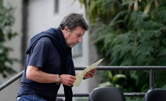 Oscar Vignale, the father of Argentine filmmaker Lucas Vignale, arrives at the Medical Examiner's Office to claim the body of his son who died alongside others when two helicopters collided in midair and crashed in Rio de Janeiro, Brazil, Monday, June 15, 2026. (AP Photo/Bruna Prado)