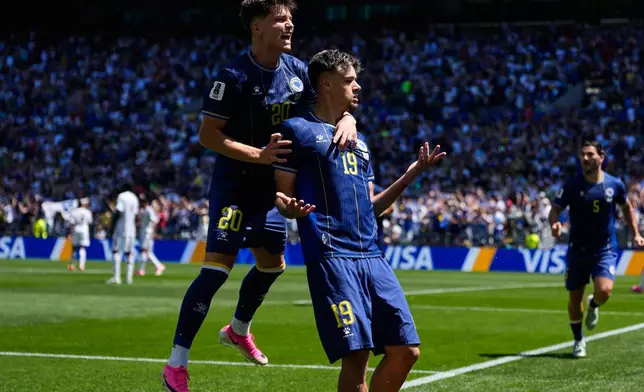 Bosnia's Kerim Alajbegovic, right, celebrates with Esmir Bajraktarevic after scoring his side's opening goal during the World Cup Group B soccer match against Qatar in Seattle, Wednesday, June 24, 2026. (AP Photo/Lindsey Wasson)