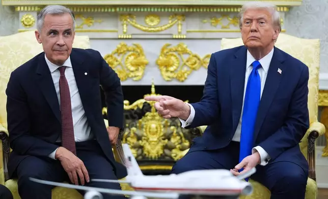 FILE - President Donald Trump and Canadian Prime Minister Mark Carney meet in the Oval Office of the White House, Oct. 7, 2025, in Washington. (AP Photo/Evan Vucci, File)