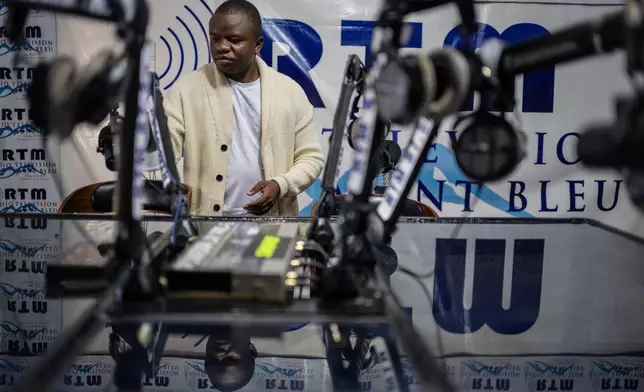 Verité Johnson works at a community radio station, providing daily awareness and updates on Ebola in Bunia, Congo, Thursday, June 4, 2026. (AP Photo/Moses Sawasawa)