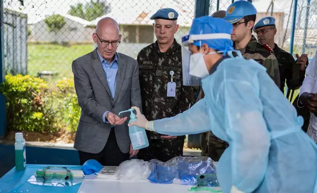 Head of the UN mission in Congo James Swan sanitizes his hands during his visit to Bunia to assess the response to the Ebola outbreak in Ituri province, Congo, Thursday, June 4, 2026. (AP Photo/Moses Sawasawa)