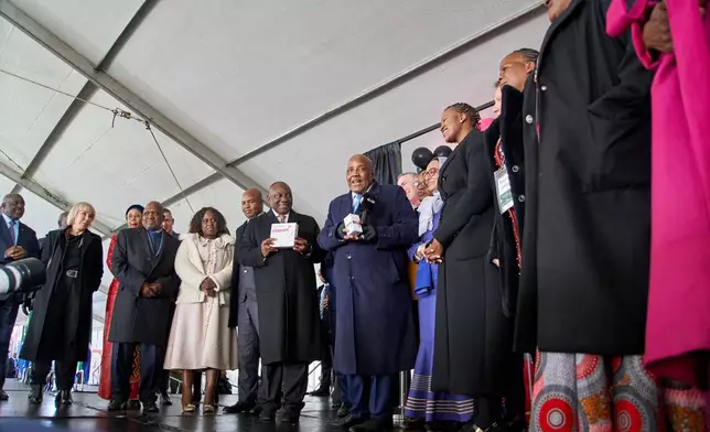 South African President, Cyril Ramaphosa and Health Minister, Aaron Motsoaledi, among other delegates, hold a box of Lenacapavir during the official launch of the drug's rollout programme in Secunda, South Africa, Friday, June 5, 2026. (AP Photo/Kayleen Morgan)
