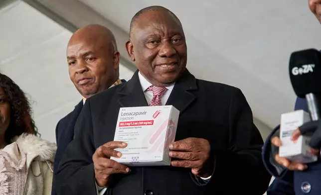 South African President, Cyril Ramaphosa holds a box of Lenacapavir during the official launch of the drug's rollout programme in Secunda, South Africa, Friday, June 5, 2026. (AP Photo/Kayleen Morgan)