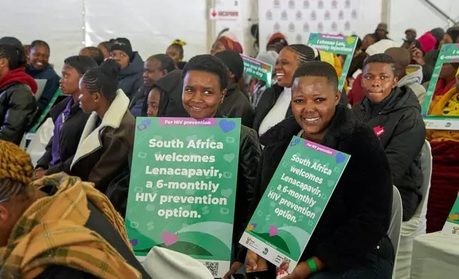 Young people hold posters as they attend the launch of the Lenacapavir rollout programme in Secunda, South Africa, Friday, June 5, 2026. (AP Photo/Kayleen Morgan)