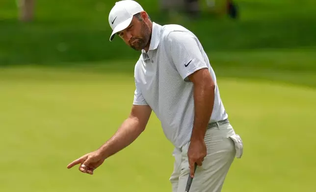 Scottie Scheffler gestures after missing his first putt on the second green in the third round of the Memorial golf tournament, Dublin, Ohio, Saturday, June 6, 2026. (AP Photo/Sue Ogrocki)