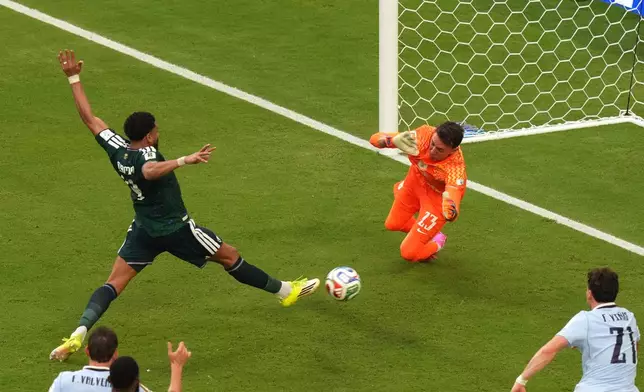 Saudi Arabia's Abdulelah Alamri (4) shoots and scores their opening goal against Uruguay goalkeeper Fernando Muslera (23) during the World Cup Group H soccer match between Saudi Arabia and Uruguay in Miami Gardens, Fla., Monday, June 15, 2026. (AP Photo/Marta Lavandier)