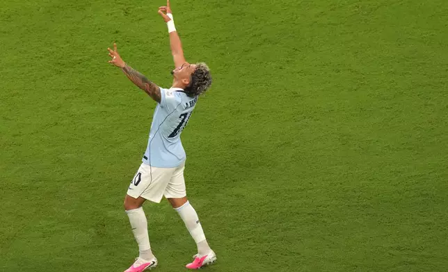 Uruguay's Maxi Araujo (20) celebrates after scoring their opening goal during the World Cup Group H soccer match between Saudi Arabia and Uruguay in Miami Gardens, Fla., Monday, June 15, 2026. (AP Photo/Marta Lavandier)