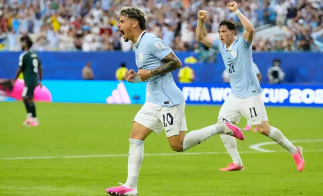 Uruguay's Maxi Araujo celebrates scoring his side's opening goal against Saudi Arabia during a World Cup Group H soccer match in Miami Gardens, Fla., Monday, June 15, 2026. (AP Photo/Lynne Sladky)