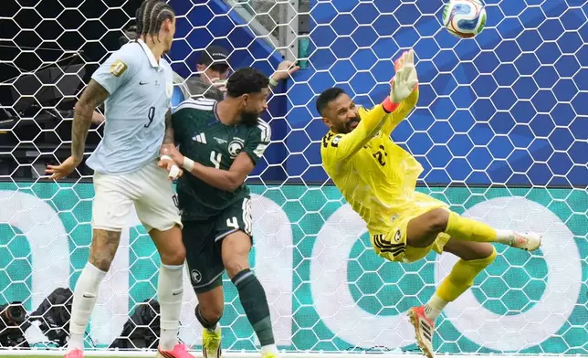 Saudi Arabia goalkeeper Mohammed Alowais stops a shot during a World Cup Group H soccer match against Uruguay in Miami Gardens, Fla., Monday, June 15, 2026. (AP Photo/Lynne Sladky)
