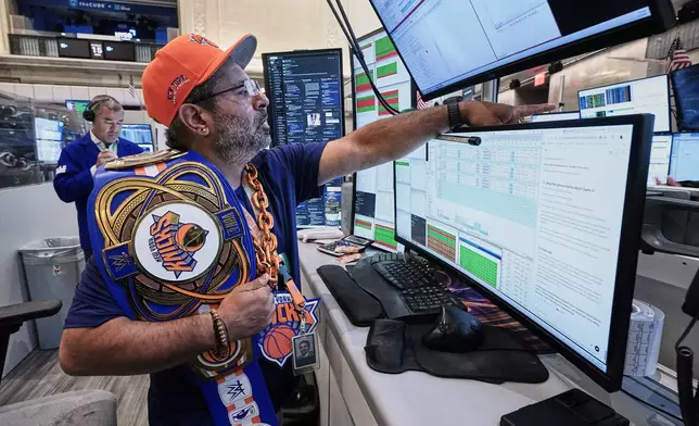 Options trader, and New York Knicks fan Ousama Fayek works on the floor of the New York Stock Exchange, Monday, June 15, 2026. (AP Photo/Richard Drew)