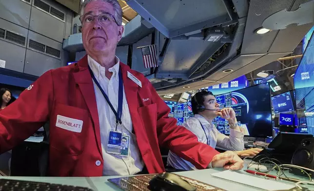 Trader Daniel Kryger, left, works on the floor of the New York Stock Exchange, Monday, June 15, 2026. (AP Photo/Richard Drew)