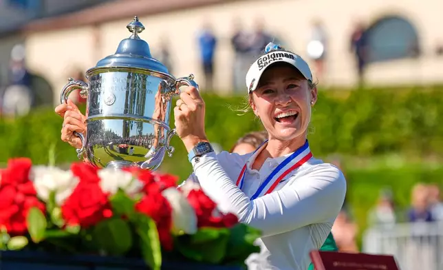 Nelly Korda holds up the trophy after winning the U.S. Women's Open golf tournament Sunday, June 7, 2026, in the Pacific Palisades area of Los Angeles. (AP Photo/Ashley Landis)