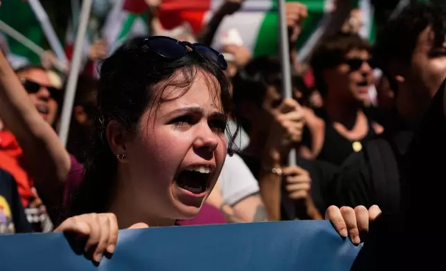 Demonstrators shout slogans as they gather during a protest organized by right-wing groups, calling for the repatriation of migrants, in Rome, Saturday, June 13, 2026. (AP Photo/Gregorio Borgia)