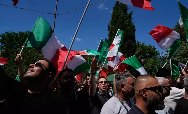 Demonstrators shout slogans as they gather during a protest organized by right-wing groups, calling for the repatriation of migrants, in Rome, Saturday, June 13, 2026. (AP Photo/Gregorio Borgia)
