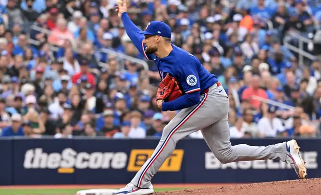 Texas Rangers starting pitcher Nathan Eovaldi (17) throws to a Toronto Blue Jays batter during the first inning of a baseball game in Toronto, Friday June 26, 2026. (Jon Blacker/The Canadian Press via AP)