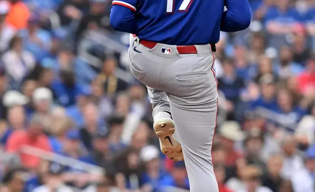 Texas Rangers starting pitcher Nathan Eovaldi winds up to deliver to a Toronto Blue Jays batter during the first inning of a baseball game in Toronto, Friday June 26, 2026. (Jon Blacker/The Canadian Press via AP)