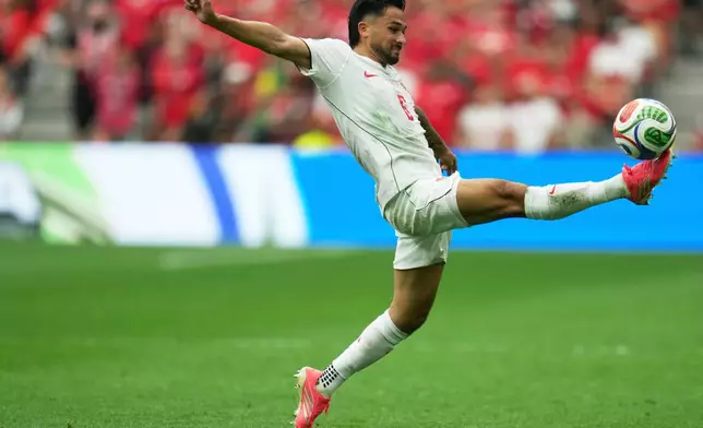 Canada's Mathieu Choiniere (6) lunges toward the ball during the World Cup Group B soccer match between Switzerland and Canada in Vancouver, British Columbia, Wednesday, June 24, 2026. (AP Photo/Abbie Parr)