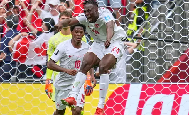 Canada's Promise David (24) celebrates after scoring during the World Cup Group B soccer match between Switzerland and Canada in Vancouver, British Columbia, Wednesday, June 24, 2026. (AP Photo/Abbie Parr)