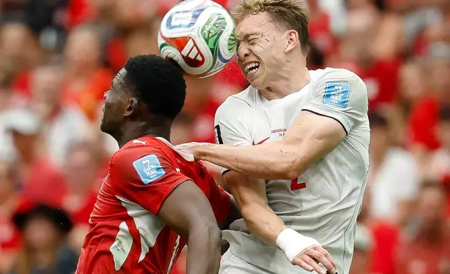 Switzerland's Breel Embolo, left, and Canada's Alistair Johnston battle for a head ball during the World Cup Group B soccer match between Switzerland and Canada in Vancouver, British Columbia, Wednesday, June 24, 2026. (Peter Klaunzer/Keystone via AP)