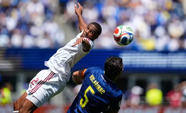 Qatar's Pedro Miguel, left, and Bosnia's Sead Kolasinac jump to head the ball during the World Cup Group B soccer match in Seattle, Wednesday, June 24, 2026. (AP Photo/Lindsey Wasson)