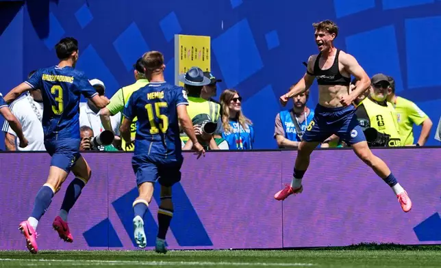 Bosnia's Ermin Mahmic, right, jumps as he celebrates with teammates after scoring his side's third goal during the World Cup Group B soccer match against Qatar in Seattle, Wednesday, June 24, 2026. (AP Photo/Lindsey Wasson)