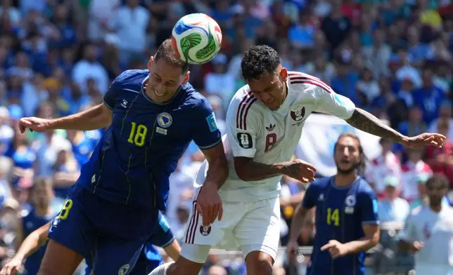 Qatar's Edmilson Junior (8), right, and Bosnia's Nikola Katic (18) jump for the ball during the World Cup Group B soccer match between Bosnia and Qatar in Seattle Wednesday, June 24, 2026. (AP Photo/Manu Fernandez)