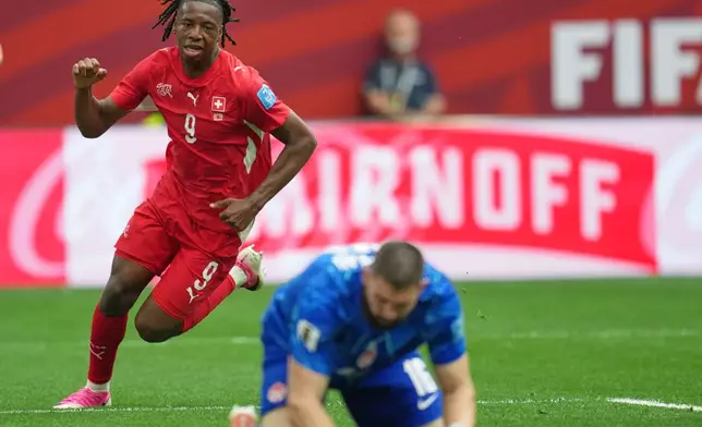 Switzerland's Johan Manzambi (9) celebrates after scoring as Canada goalkeeper Maxime Crepeau reacts during the World Cup Group B soccer match between Switzerland and Canada in Vancouver, British Columbia, Wednesday, June 24, 2026. (AP Photo/Abbie Parr)