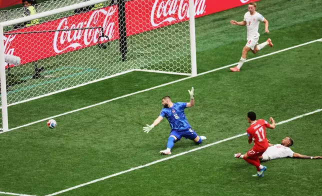 Switzerland's Ruben Vargas (17) scores a goal past Canada goalkeeper Maxime Crepeau (16) during the World Cup Group B soccer match between Switzerland and Canada in Vancouver, British Columbia, Wednesday, June 24, 2026. (AP Photo/Kaleb Tatum)