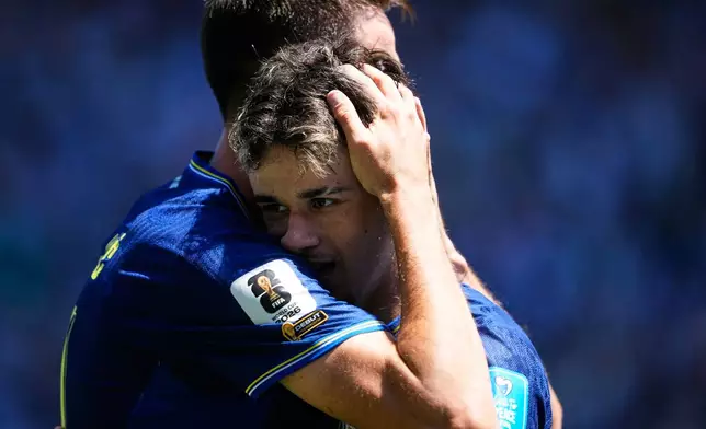 Bosnia's Kerim Alajbegovic, right, is embraced by Sead Kolasinac after scoring their opening goal during the World Cup Group B soccer match against Qatar in Seattle, Wednesday, June 24, 2026. (AP Photo/Lindsey Wasson)
