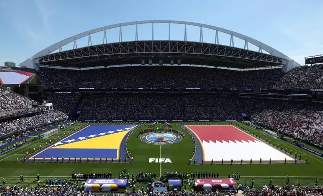 Bosnian and Qatari flags are seen on the ptich before the World Cup Group B soccer match between Bosnia and Qatar in Seattle, Wednesday, June 24, 2026. (AP Photo/Maddy Grassy)