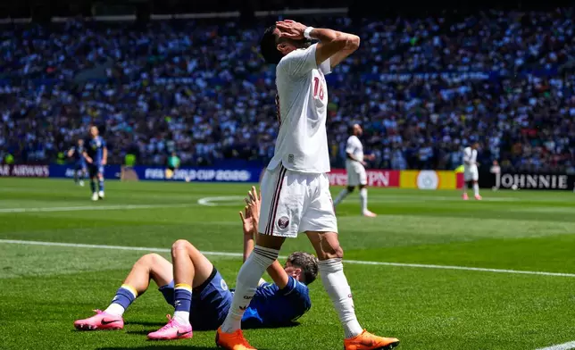 Qatar's Sultan Albrake, right, reacts after fouling against Bosnia's Nidal Celik, left, during the World Cup Group B soccer match in Seattle, Wednesday, June 24, 2026. (AP Photo/Lindsey Wasson)
