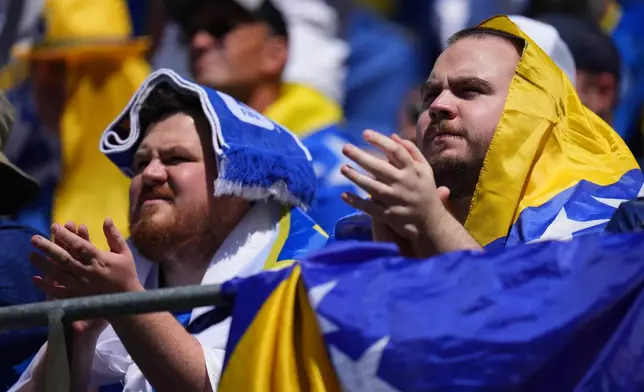 Bosnian fans wait for the start of the World Cup Group B soccer match between Bosnia and Qatar in Seattle Wednesday, June 24, 2026. (AP Photo/Manu Fernandez)