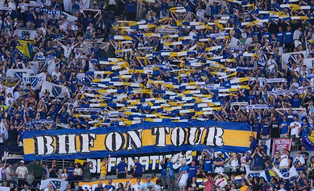 Bosnia fans cheer during the singing of the national anthem ahead of World Cup Group B soccer match against Qatar in Seattle, Wednesday, June 24, 2026. (AP Photo/Lindsey Wasson)