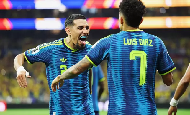 Colombia's Luis Diaz (7) celebrates with Daniel Munoz (2) after scoring their second goal during the World Cup Group K soccer match between Uzbekistan and Colombia in Mexico City, Wednesday, June 17, 2026. (AP Photo/Ashtin Barker)
