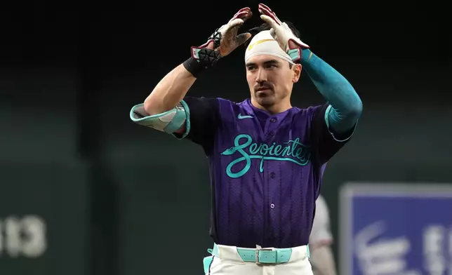 Arizona Diamondbacks' Corbin Carroll reacts after hitting a three-run triple against the Minnesota Twins in the eighth inning of a baseball game, Friday, June 19, 2026, in Phoenix. (AP Photo/Rick Scuteri)