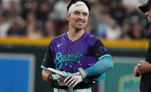 Arizona Diamondbacks' Corbin Carroll, left, reacts after hitting a double against the Minnesota Twins in the fifth inning of a baseball game, Friday, June 19, 2026, in Phoenix. (AP Photo/Rick Scuteri)