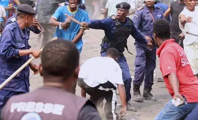 Police clash with protesters at a demonstration as Congo's opposition rejects a proposed constitutional change in Kinshasa, Congo, Friday, June 12, 2026. (AP Photo/Ekutshu Yannick)