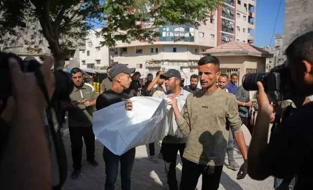 Mourners carry the bodies of two Palestinian girls Zeina Safadi, and her sister Lana, who were killed during an overnight Israeli airstrike that damaged their home, during their funeral in Gaza city, Saturday, June 20, 2026. (AP Photo/Abdel Kareem Hana)