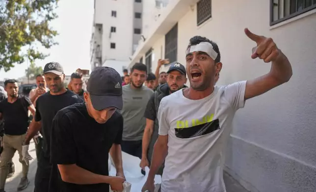 Mourners carry the bodies of two Palestinian girls Zeina Safadi, and her sister Lana, who were killed during an overnight Israeli airstrike that damaged their home, during their funeral in Gaza city, Saturday, June 20, 2026. (AP Photo/Abdel Kareem Hana)
