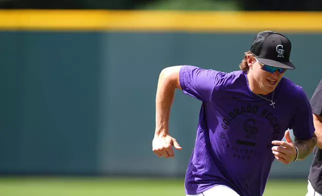 Colorado Rockies outfielder Cole Carrigg warms up before a baseball game against the Chicago Cubs, Tuesday, June 9, 2026, in Denver. (AP Photo/David Zalubowski)