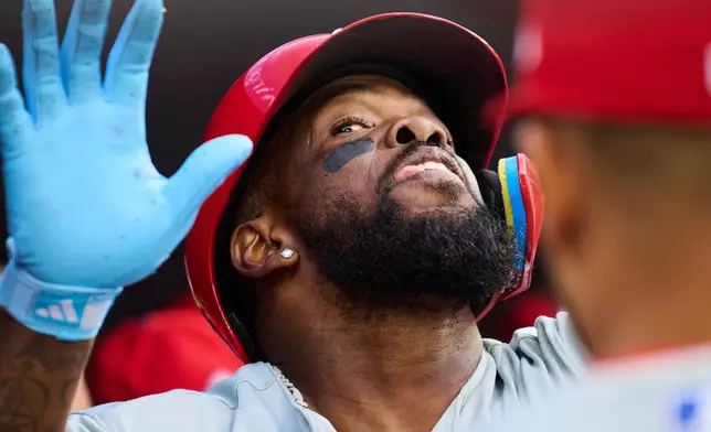 Philadelphia Phillies' Adolis Garcia celebrates with teammates after hitting a two-run home run against the Toronto Blue Jays during second-inning baseball game action in Toronto, Monday, June 8, 2026. (Sammy Kogan/The Canadian Press via AP)