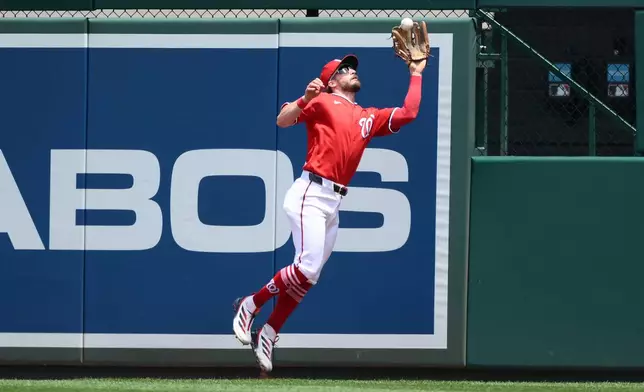 Washington Nationals right fielder Dylan Crews makes a leaping catch on a fly ball by Seattle Mariners' Julio Rodriguez for the out during the first inning of a baseball game, Sunday, June 14, 2026, in Washington. (AP Photo/Nick Wass)