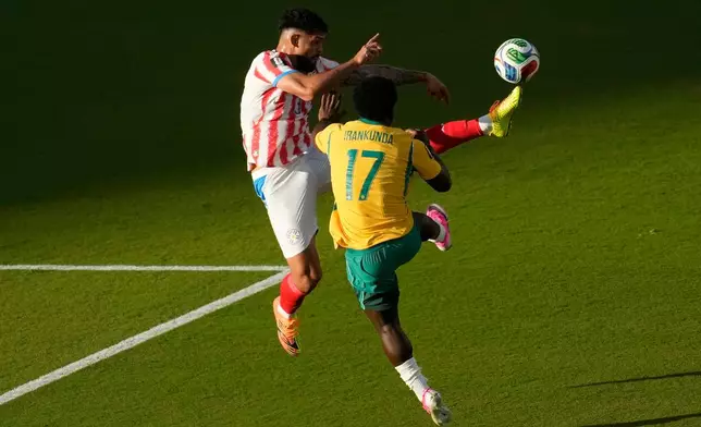 Paraguay's Omar Alderete (3) kicks the ball over Australia's Nestory Irankunda (17) during the World Cup Group D soccer match between Paraguay and Australia in Santa Clara, Calif., near San Francisco, Thursday, June 25, 2026. (AP Photo/Jeff Chiu)