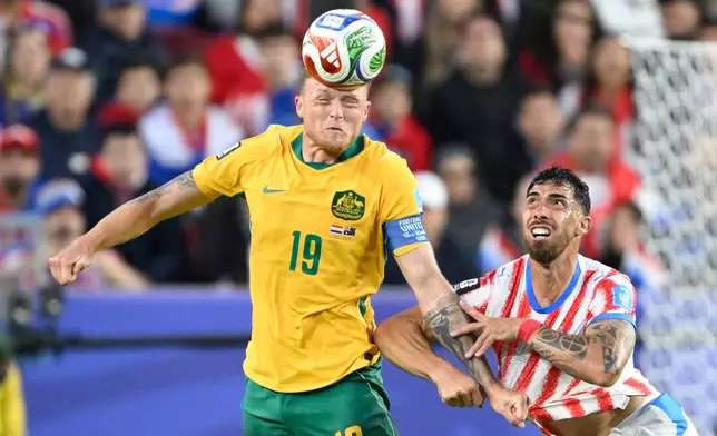 Australia's Harry Souttar (19) battles for the ball with Paraguay's Gabriel Avalos (21) during the World Cup Group D soccer match between Paraguay and Australia in Santa Clara, Calif., near San Francisco, Thursday, June 25, 2026. (AP Photo/Eakin Howard)