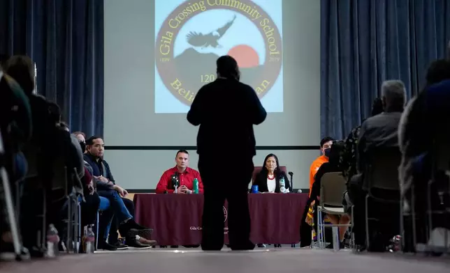 FILE - U.S. Interior Secretary Deb Haaland, right, and Assistant Secretary for Indian Affairs Bryan Newland, left, listen as April Hiosik Ignacio, center, speaks, Jan. 20, 2023, in Laveen, Ariz. (AP Photo/Matt York, File)