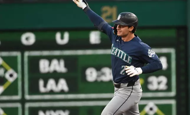 The Seattle Mariners' Cole Young celebrates a two-run home run against the Pittsburgh Pirates during the seventh inning in a baseball game, Tuesday, June 23, 2026, in Pittsburgh. (AP Photo/Philip G. Pavely)