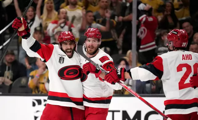 Carolina Hurricanes right wing Andrei Svechnikov, center, celebrates his goal with defenseman Shayne Gostisbehere, left, and center Sebastian Aho during the third period in Game 3 of the NHL hockey Stanley Cup Final series against the Vegas Golden Knights, Saturday, June 6, 2026, in Las Vegas. (AP Photo/John Locher)