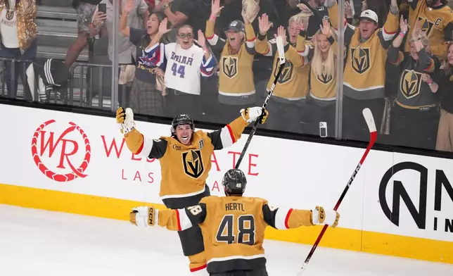 Vegas Golden Knights right wing Mitch Marner, top, celebrates his goal with center Tomas Hertl during the second period in Game 3 of the NHL hockey Stanley Cup Final series against the Carolina Hurricanes, Saturday, June 6, 2026, in Las Vegas. (AP Photo/Candice Ward)