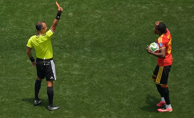 Referee Dario Herrera shows a red card to Belgium's Nathan Ngoy (25) during the World Cup Group G soccer match between Belgium and Iran in Inglewood, Calif., near Los Angeles, Sunday, June 21, 2026. (AP Photo/Jayne Kamin-Oncea)